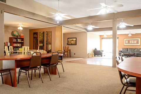 a dining room and living room with a table and chairs